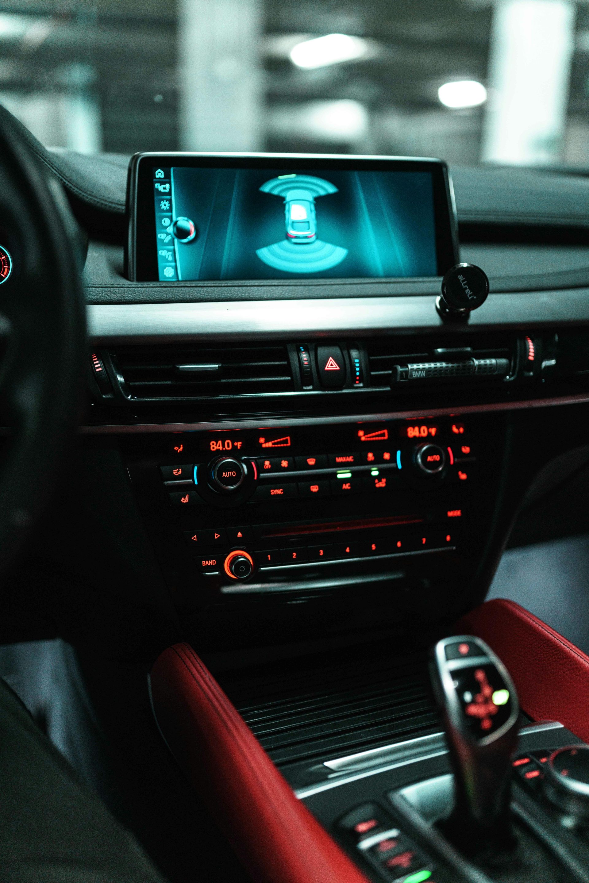 Close-up of a car dashboard with a digital screen and controls.