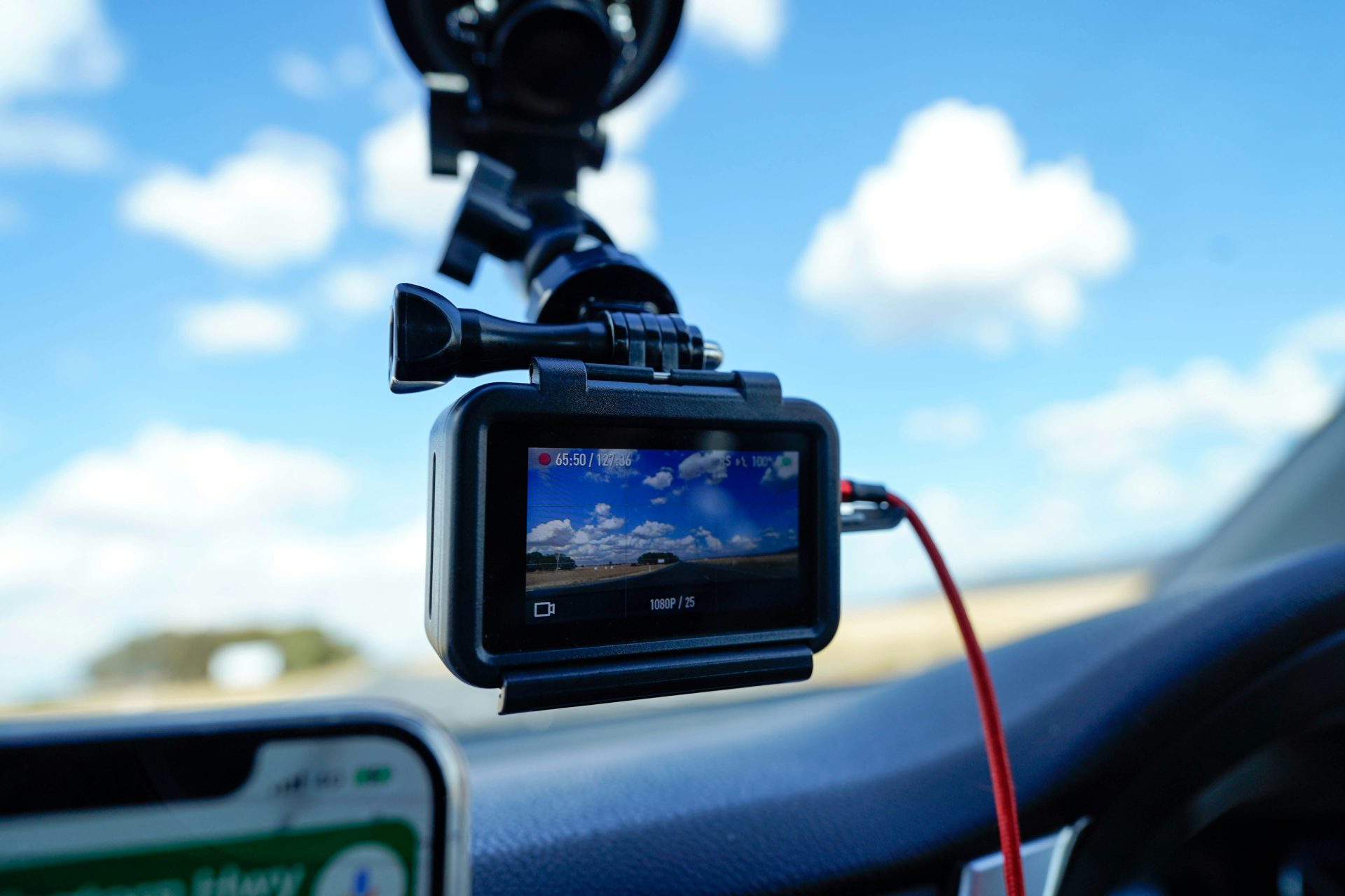a car dashboard with a dash camera attached to it